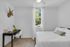 Bedroom with white linens | The Cardinal at West Center | Off Campus Apartments