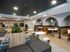 Modern communal lounge area featuring stylish seating, geometric wall tiles, and ambient lighting, perfect for social gatherings.