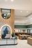 Modern apartment lobby with sleek design featuring a stylish reception desk, cozy seating area, and elegant lighting.