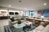 Stylish modern living space featuring cozy sofas, vibrant decor, and elegant lighting, ideal for relaxation and entertaining.