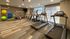Modern fitness center featuring state-of-the-art treadmills, cycling machines, and vibrant exercise balls in a spacious, motivational environment.