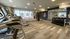 Modern fitness center with state-of-the-art treadmills, versatile weight rack, and ample floor space for workouts, accented by natural light and sleek design.