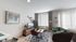 Bright and modern living area with stylish furniture, cozy seating, and natural light through large windows.