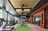Modern gym with state-of-the-art equipment, large windows, and vibrant accents, perfect for a dynamic workout experience.