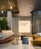 Modern lounge area boasting elegant seating, lush greenery, and stylish lighting with an inspiring quote 'The Future is Yours' adorning the wall.