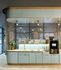 Modern kitchen nook with stylish light blue cabinetry, elegant fixtures, and a sleek coffee machine setup.