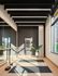 Bright and modern fitness area with sleek mirrored walls, exercise mats, and elegant plant decor.