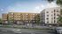 Contemporary apartment complex featuring a stylish blend of wood and brick facade, with a bustling street view and ample windows for natural light.