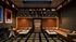 Chic entertainment room featuring luxurious leather seating, stylish wall art, and a stunning retro jukebox under a dazzling starry ceiling.