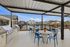 Inviting outdoor patio with modern grilling station, stylish seating, and scenic community views for perfect gatherings.