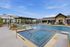 Elegant outdoor pool area featuring luxurious sun loungers and shaded seating, perfect for relaxation and leisure in a serene setting.