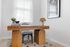Chic home office space showcasing a modern wooden desk, stylish decor, and framed wall art, perfect for productivity and creativity.
