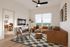 Modern living room with stylish decor, featuring a cozy leather sectional sofa, patterned rug, and a large window with a scenic view.