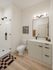 Modern bathroom with elegant finishes featuring a glass-enclosed shower, stylish vanity, and sleek fixtures.