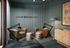Modern podcast recording studio with chic armchairs, stylish decor, and ambient lighting, perfect for creative sessions.
