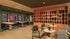 Modern communal space with chic decor, featuring a cozy lounge area, stylish seating, and vibrant wall accents.