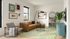 Bright living room with modern decor, featuring a tan sofa, stylish artwork, and a cozy accent chair. Large mirror reflects the open kitchen with sleek barstools, perfect for entertaining.
