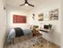Charming bedroom with stylish decor, featuring cozy bed, modern desk setup, and artistic wall accents.