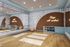 Elegant fitness room featuring modern design with motivational neon sign, hardwood floors, large mirror, yoga mats, and exercise equipment.