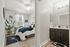 Cozy bedroom featuring modern decor, a comfortable bed, and a sleek, connected bathroom with contemporary fittings.