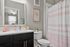 Chic bathroom with modern vanity, stylish decor, and elegant shower curtain for a refreshing experience.