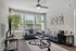 Bright and modern living room with large windows, elegant gray sofas, and stylish wall art, perfect for a chic urban lifestyle.