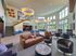 Luxurious open-concept lounge with modern decor, plush seating, and expansive windows offering ample natural light.
