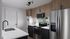 Modern kitchen with sleek appliances, granite countertops, and elegant wood cabinetry showcasing a contemporary style.