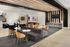 Modern lounge area with stylish seating, elegant decor, and a sleek entertainment wall, ideal for social gatherings.