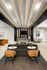 Modern lobby featuring chic wooden ceiling slats, stylish seating areas, and contemporary decor, creating a warm and inviting atmosphere.