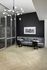 Chic modern seating area with elegant gray sofas, stylish round tables, and contemporary chandelier, ideal for cozy gatherings.