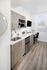 Contemporary kitchen with sleek cabinetry, stainless steel fixtures, and ample natural light from large window.