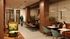 Modern and inviting communal workspace with stylish seating, elegant wooden accents, and a vibrant atmosphere.