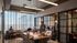 Modern communal space with large windows, stylish lighting, glass partitions, and comfortable seating ideal for work and collaboration.