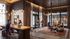 Modern co-working space with stylish lighting, communal seating, and lively atmosphere; perfect for networking and productivity.