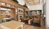 Inviting lounge area with a warm fireplace, wooden bookshelves, stylish seating, and vibrant decor; perfect for relaxation and entertaining.