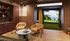 Chic entertainment room with elegant leather seating, modern decor, and a state-of-the-art golf simulator for ultimate relaxation.