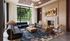 Elegant living room featuring modern furniture, a cozy fireplace, large windows with lush outdoor views, and stylish decor.