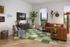Chic living room boasting a modern leather sofa, vibrant green rug, and stylish decor creating a cozy and inviting ambiance.