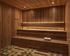 Luxurious sauna room with elegant wood paneling and soft ambient lighting.