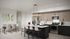 Modern kitchen and dining area with sleek black island, stainless steel appliances, and stylish pendant lighting.