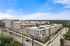 Modern apartment complex with contemporary design, featuring clean lines and multiple levels set against a vibrant blue sky.