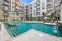 Luxurious apartment complex with a stunning outdoor pool, modern design, and stylish balcony views.