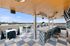Chic rooftop terrace with stylish bar seating and panoramic city skyline views, perfect for social gatherings.