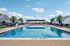 Luxurious outdoor pool area with chic loungers, vibrant umbrellas, and clear blue water, perfect for relaxation and leisure.
