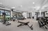 Modern fitness center with state-of-the-art gym equipment, treadmills, and a mirrored wall, offering a bright and open workout space.