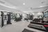 Modern fitness center with state-of-the-art gym equipment, including treadmills, weights, and resistance machines, in a spacious and bright setting.
