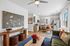 Contemporary open-plan living space with stylish decor, featuring a cozy sitting area, modern kitchen, and chic dining setup.