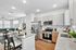 Modern open-concept living space showcasing a stylish kitchen with sleek stainless steel appliances, granite countertops, and a cozy living area perfect for relaxation.