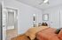 Inviting bedroom featuring stylish decor, bright natural lighting, and a convenient ensuite bathroom.